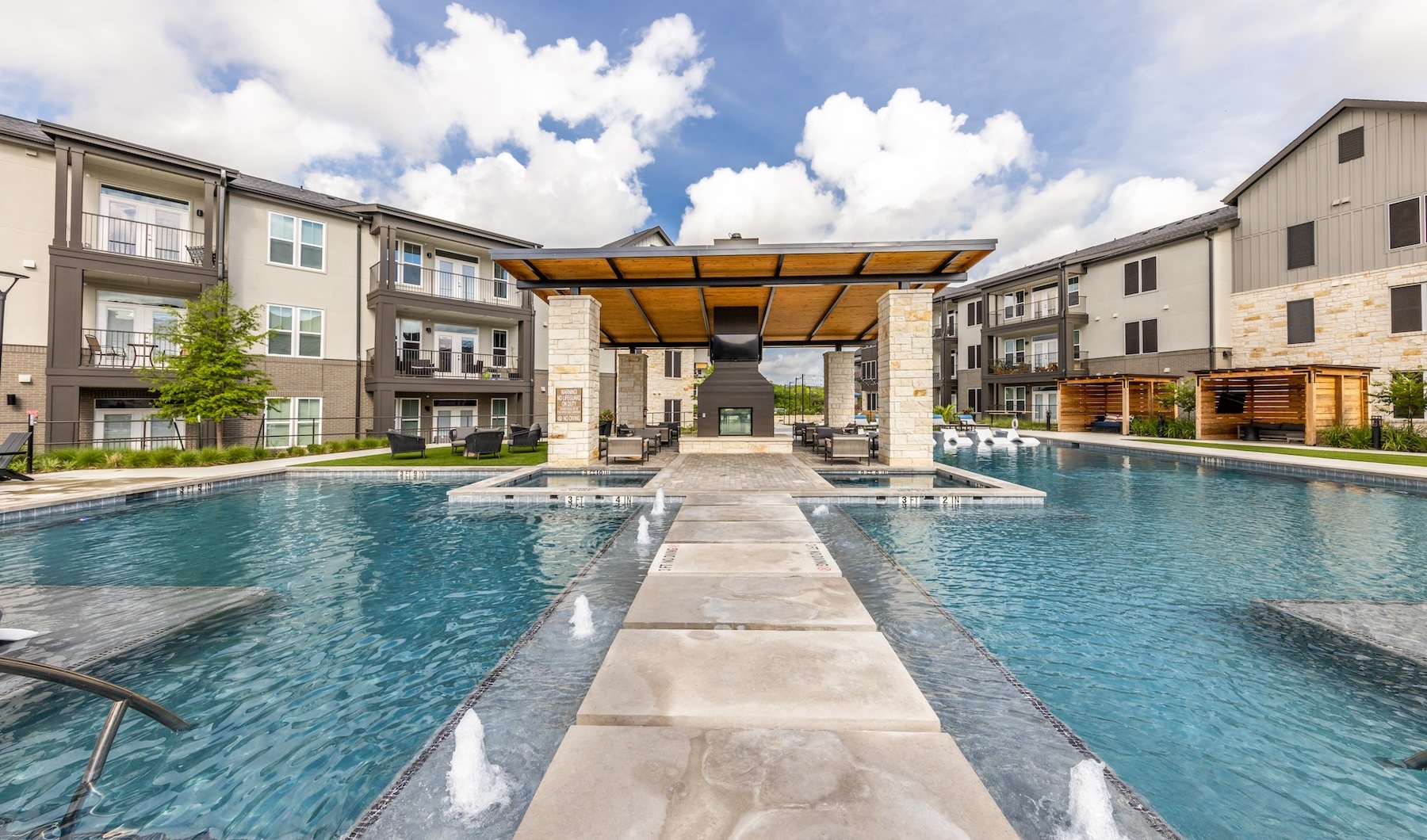 Resort-style swimming pool with lounge seating